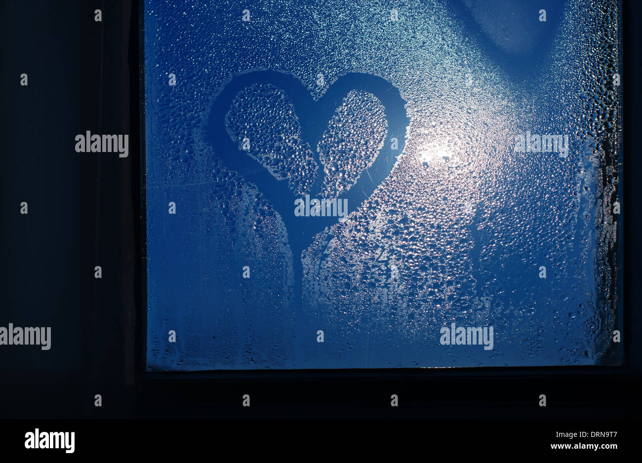 Moonlight through the window. Sweaty glass and heart shape Stock Photo