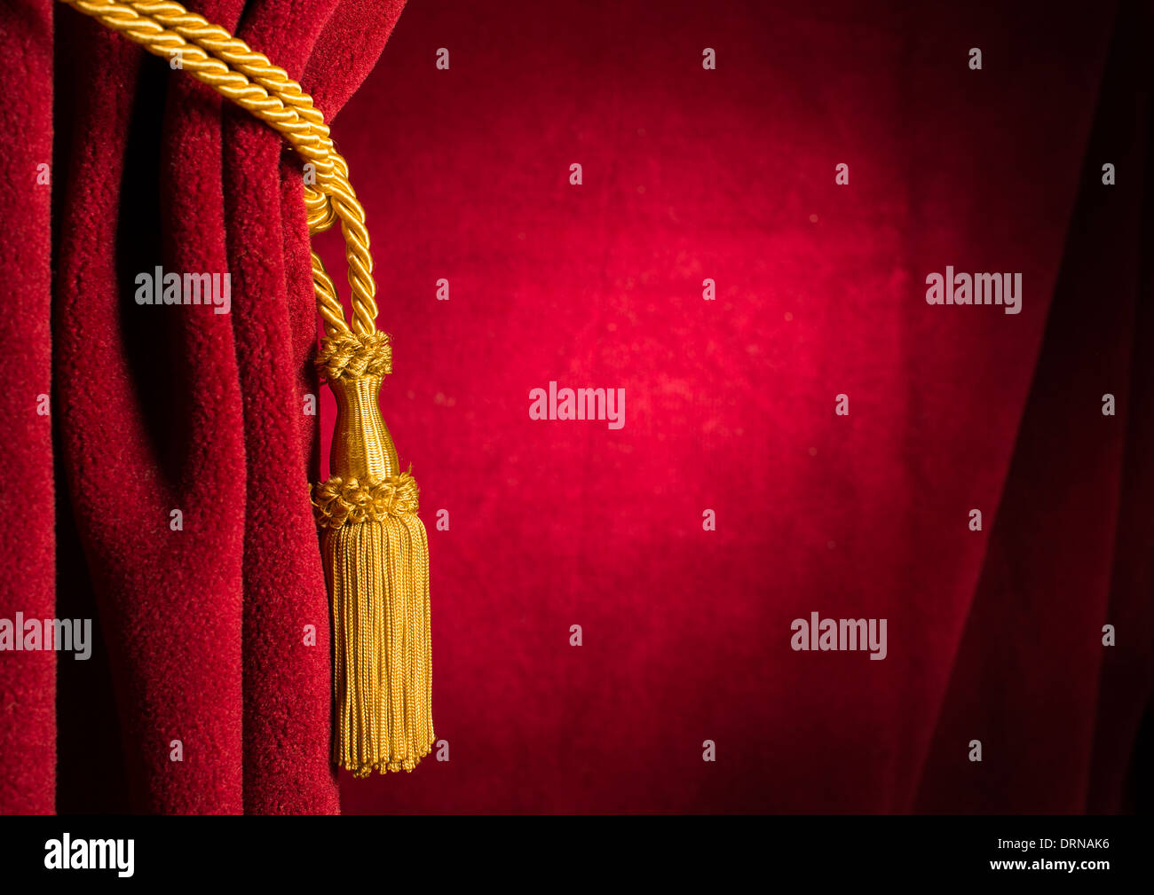 Red theatre curtain and yellow tassels Stock Photo