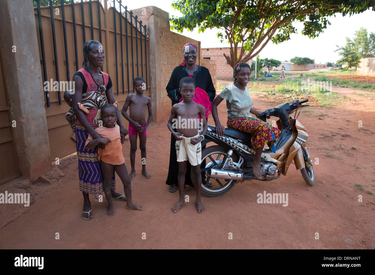 women standing outside home in Bobo Dioulasso, Burkina Faso, Africa with their children Stock Photo