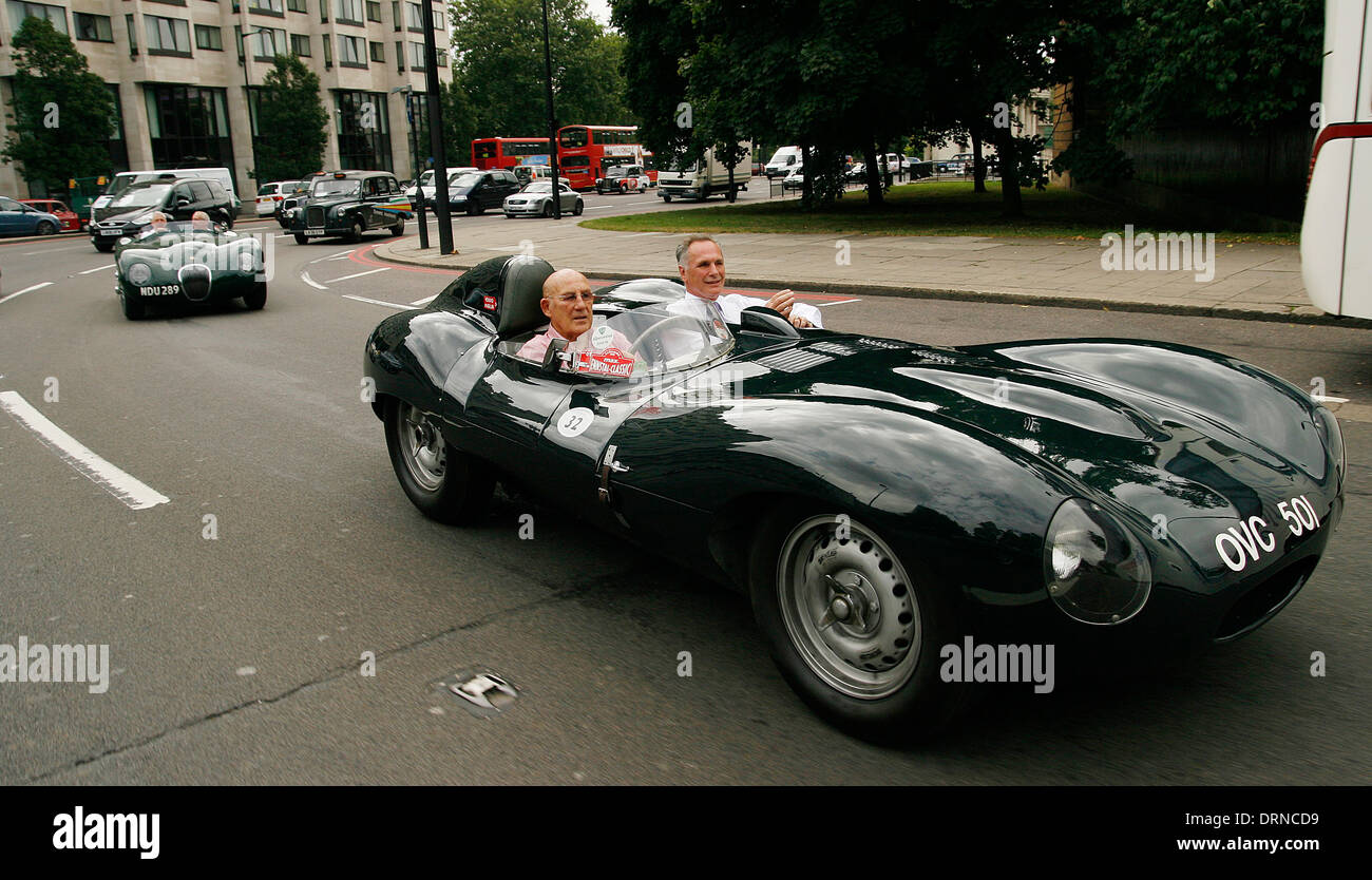 Sir Stirling Moss driving a Jaguar XK around Hyde Park Corner in London