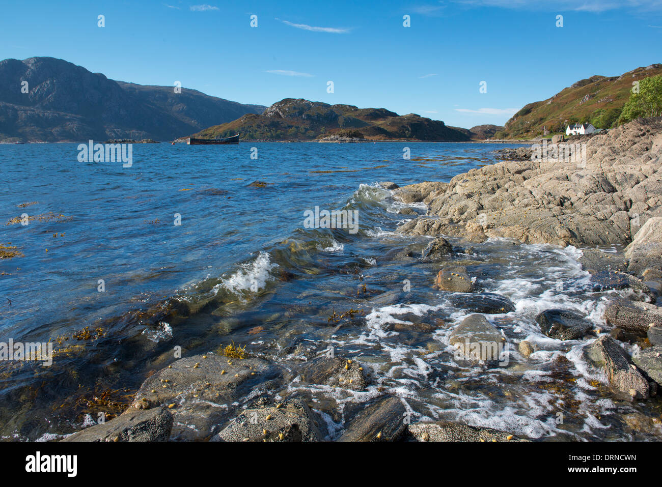 landscape of inverie bay loch nevis knoydart on the west coast of scotland with good foreground interest and a blue sky Stock Photo