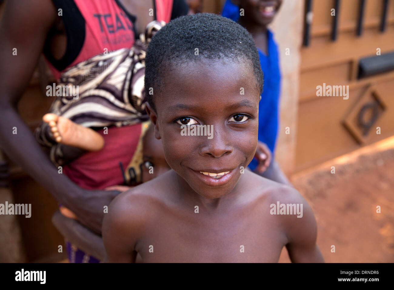 young boy standing outside his home in Bobo Dioulasso, Burkina Faso, Africa Stock Photo