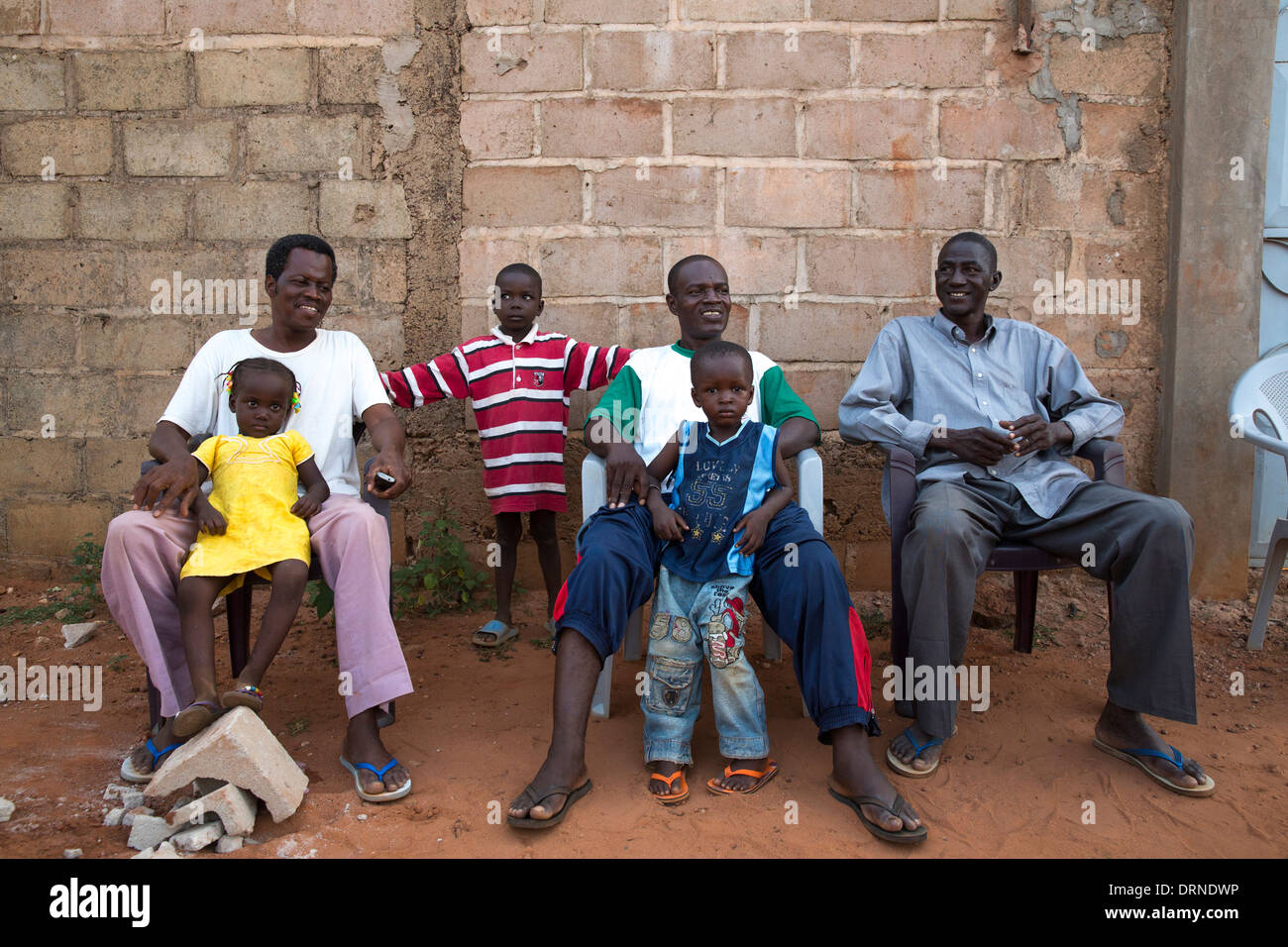 men and children outside home in Bobo Dioulasso, Burkina Faso, Africa Stock Photo