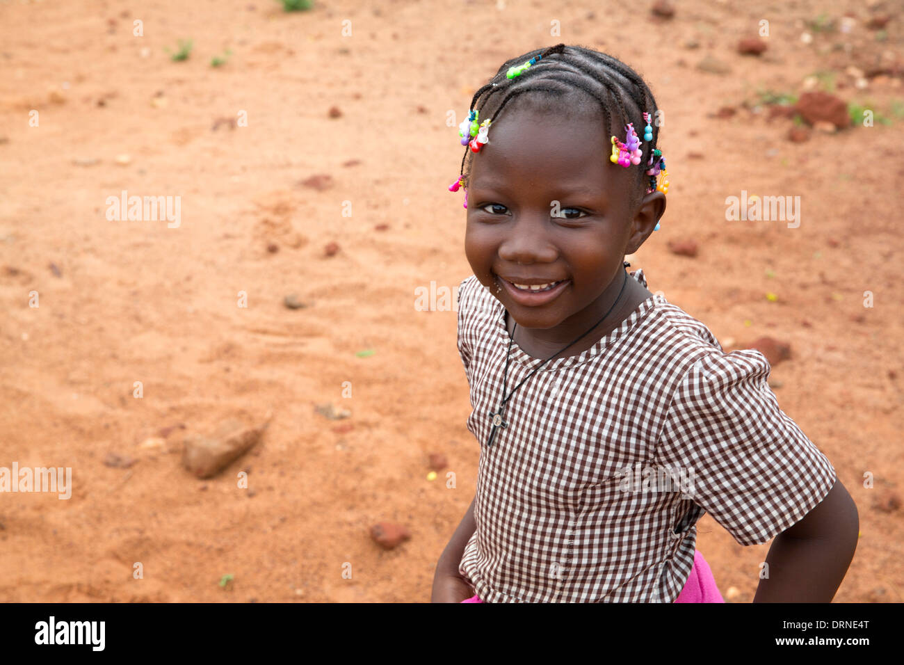 young girl outside church supported school in Bobo Dioulasso, Burkina Faso, Africa Stock Photo