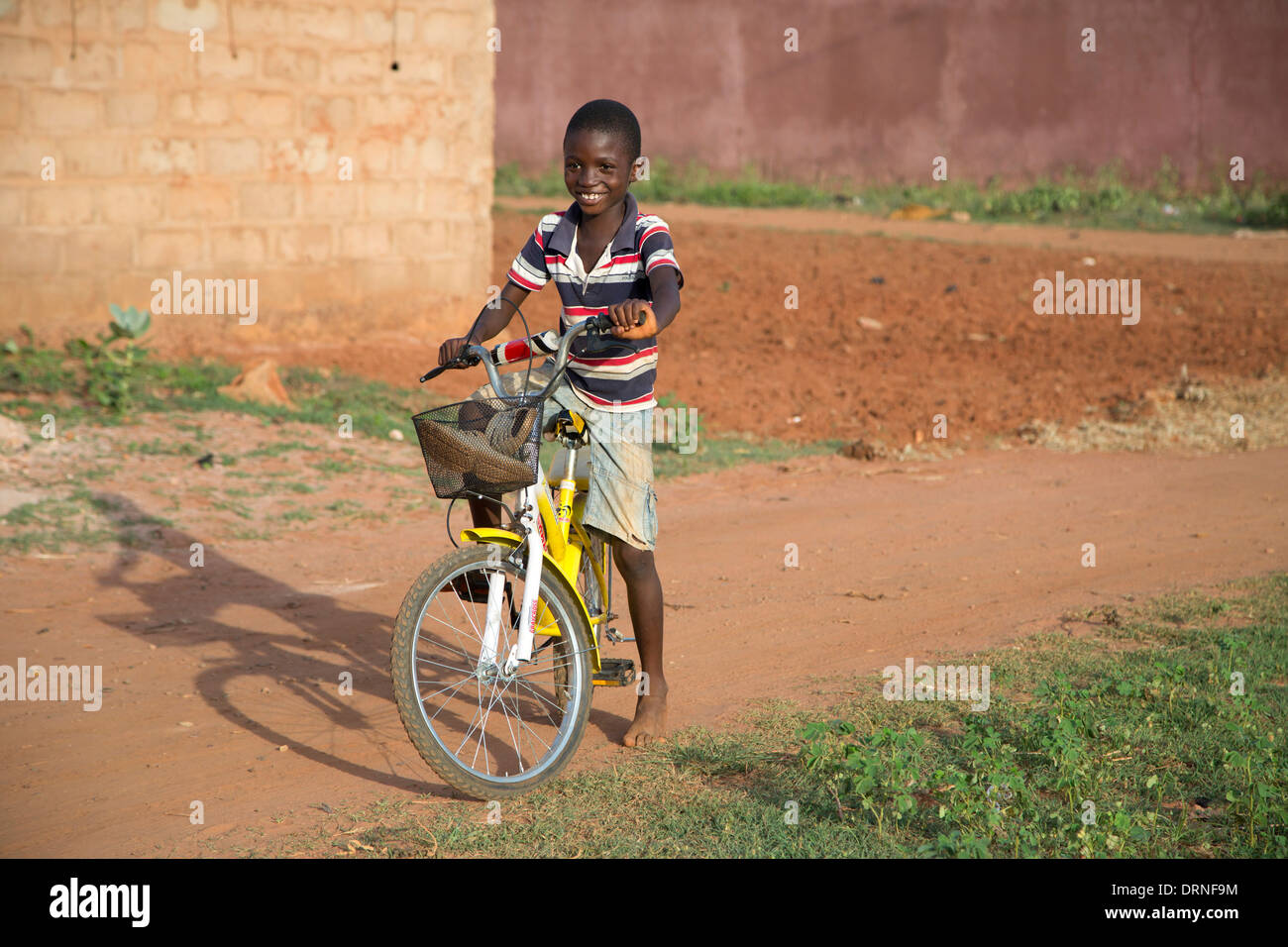 boy on bicycle in Bobo Dioulasso, Burkina Faso Stock Photo