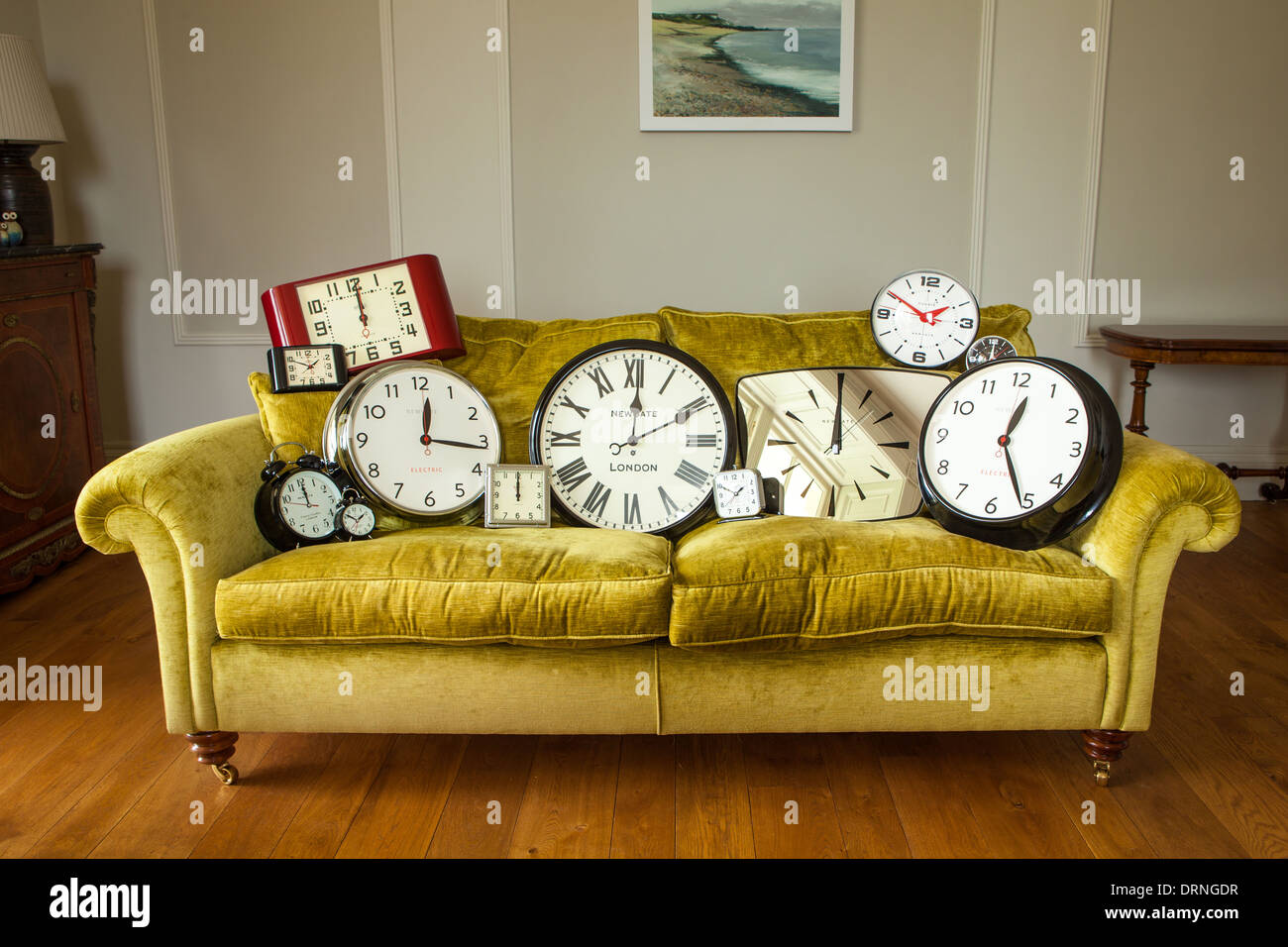 clocks set up on a sofa in a home Stock Photo