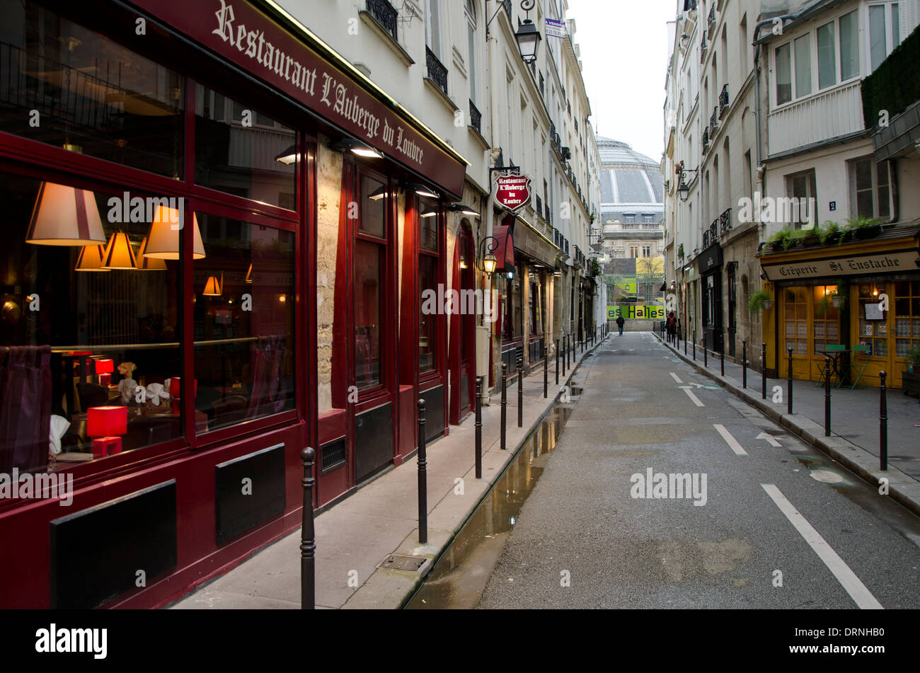 Street in paris with restaurant l' Auberge du louvre and Creperie, Rue sauval , France Stock Photo
