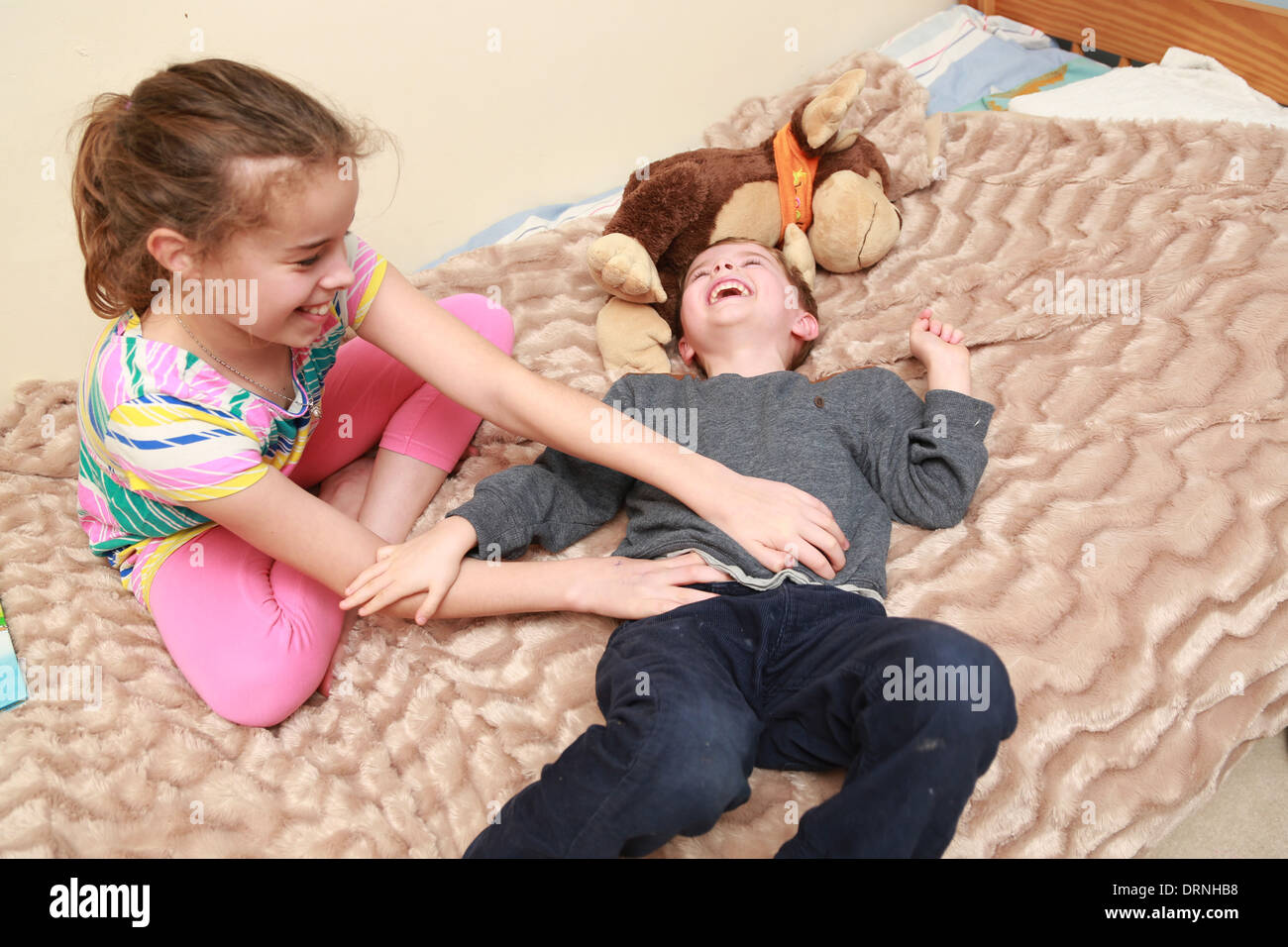 Sister tickling her younger brother Stock Photo 66242828 Alamy