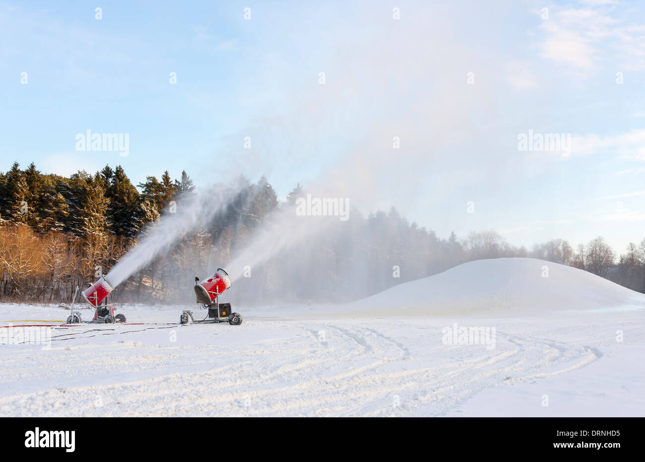 Snow blowing machines or snow cannons making snow Stock Photo Alamy