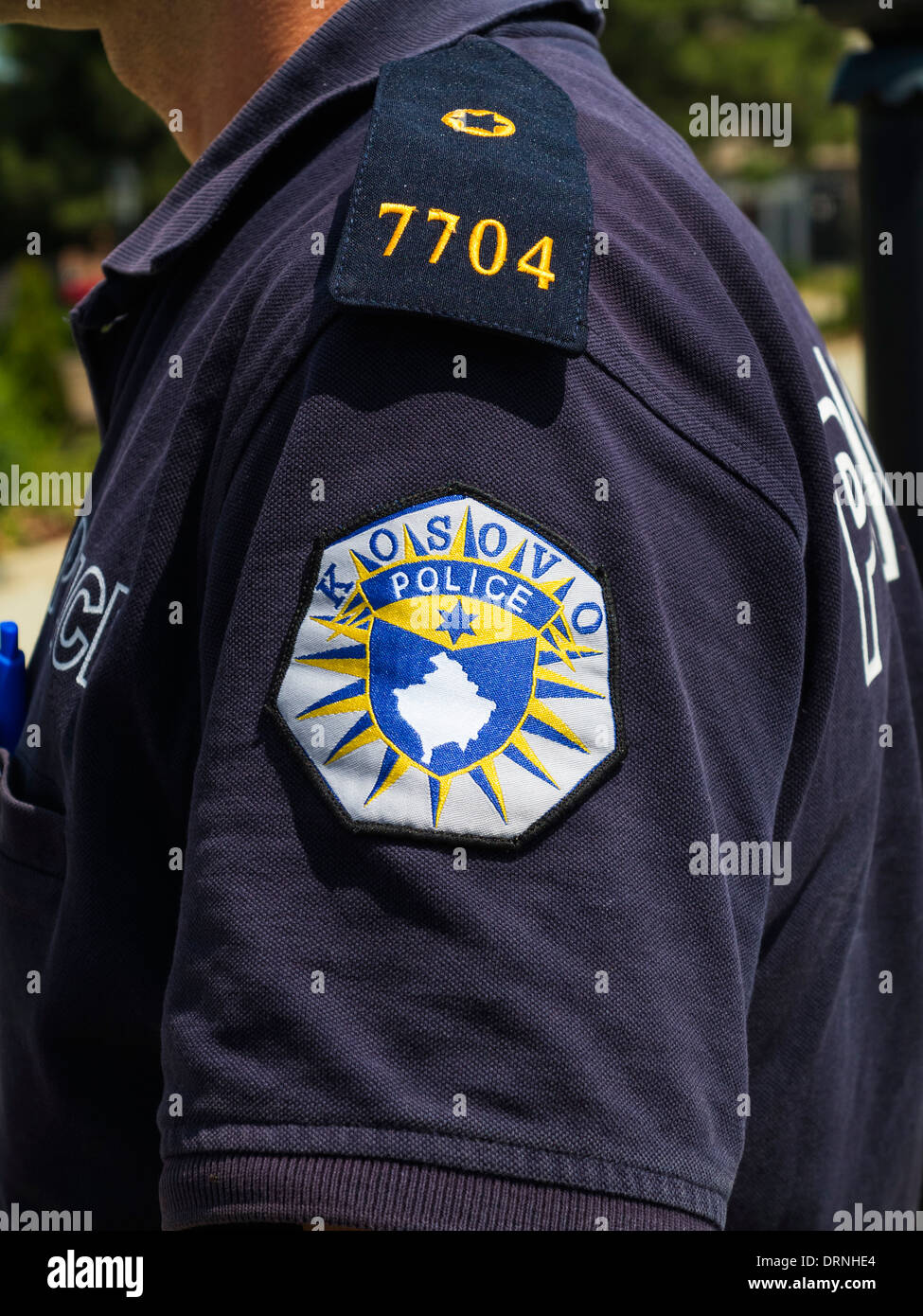 Policeman in Kosovo, Europe showing the emblem of the Kosovo police on his uniform Stock Photo