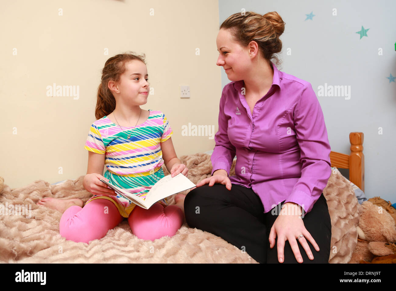 Mum And 9 Yr Old Girl Together In The Bedroom Stock Photo