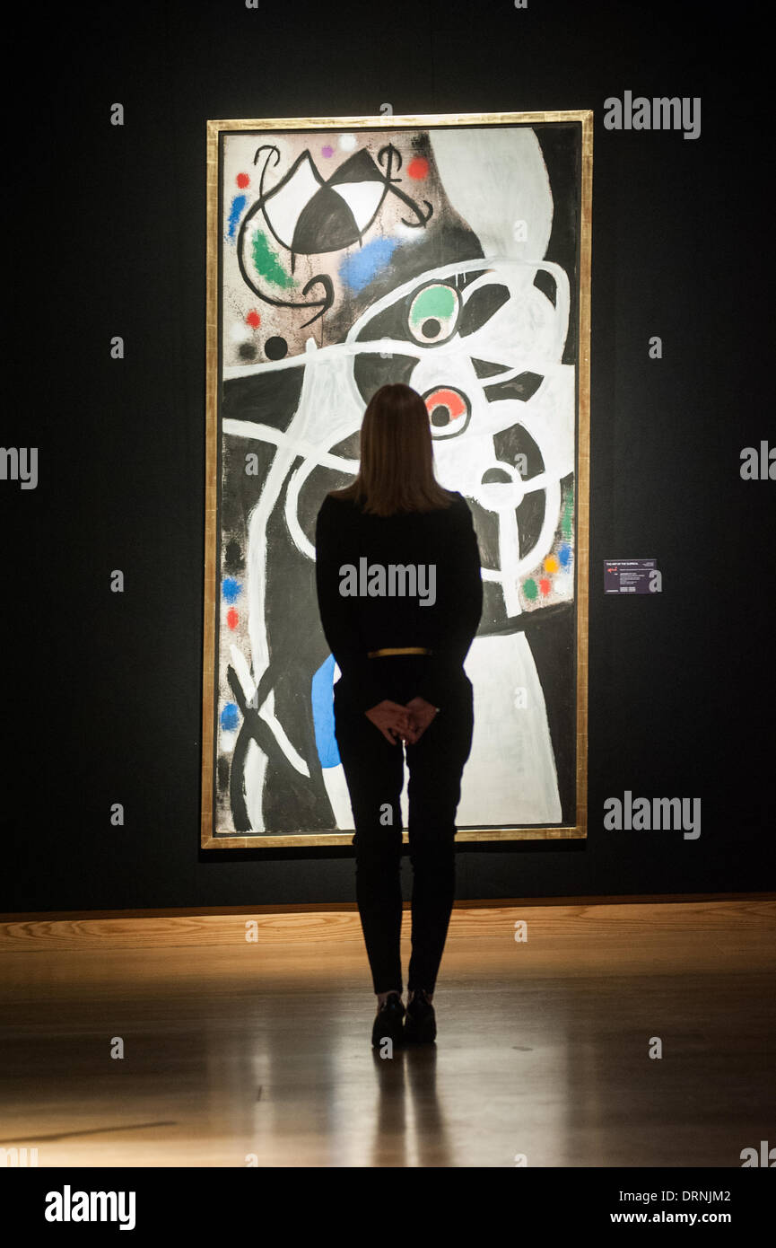 London, UK - 30 January 2014: a staff member poses in front of ‘Femmes et oiseaux, 1968’ by Joan Miro (est £2.5-3.5 million) that will go on sale on the 4th February at Christie’s Credit:  Piero Cruciatti/Alamy Live News Stock Photo