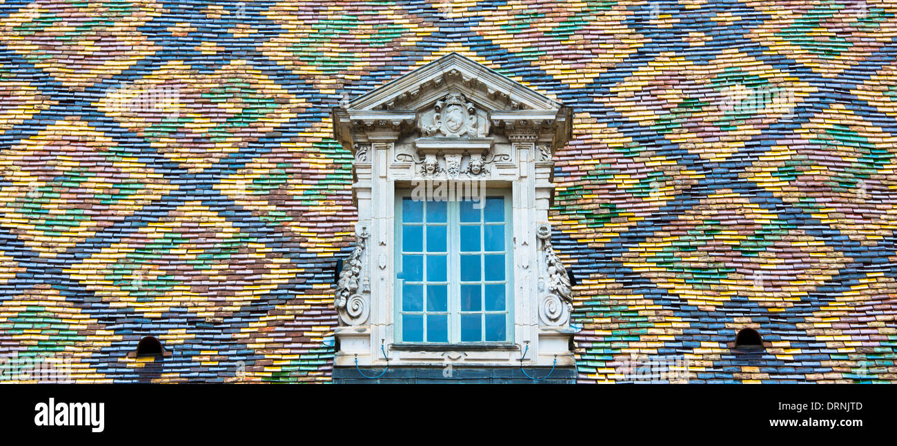 Traditional polychrome roof tiles of Hotel de Vogue in Rue de la Chouette in Dijon in the Burgundy region of France Stock Photo