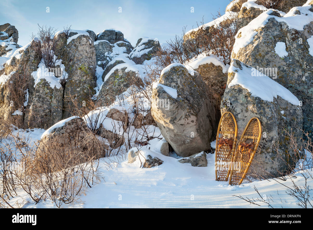 winter landscape with sandstone rocks and classic Bear Paw snowshoes Stock Photo