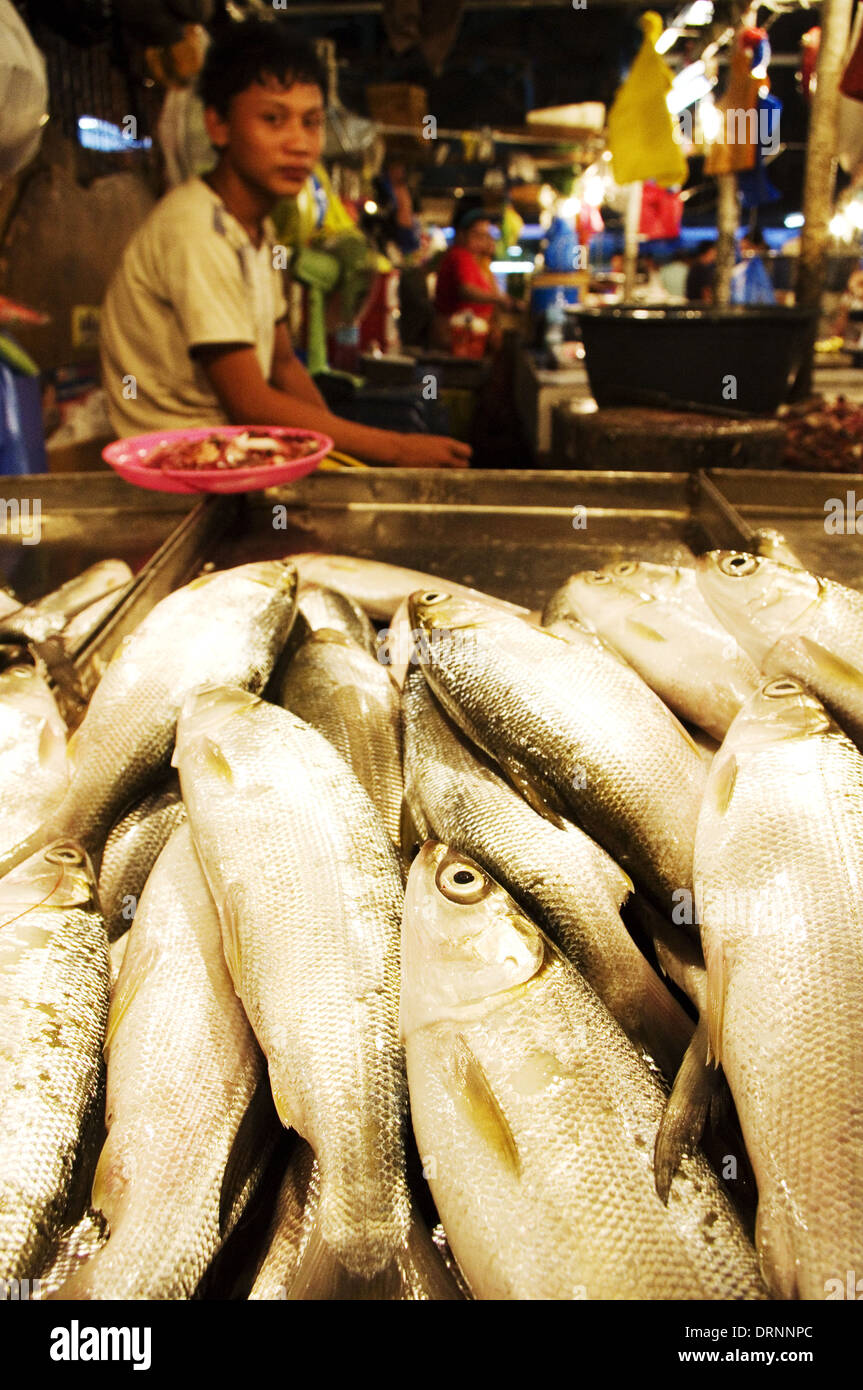 asian kid vendor in fish market Stock Photo