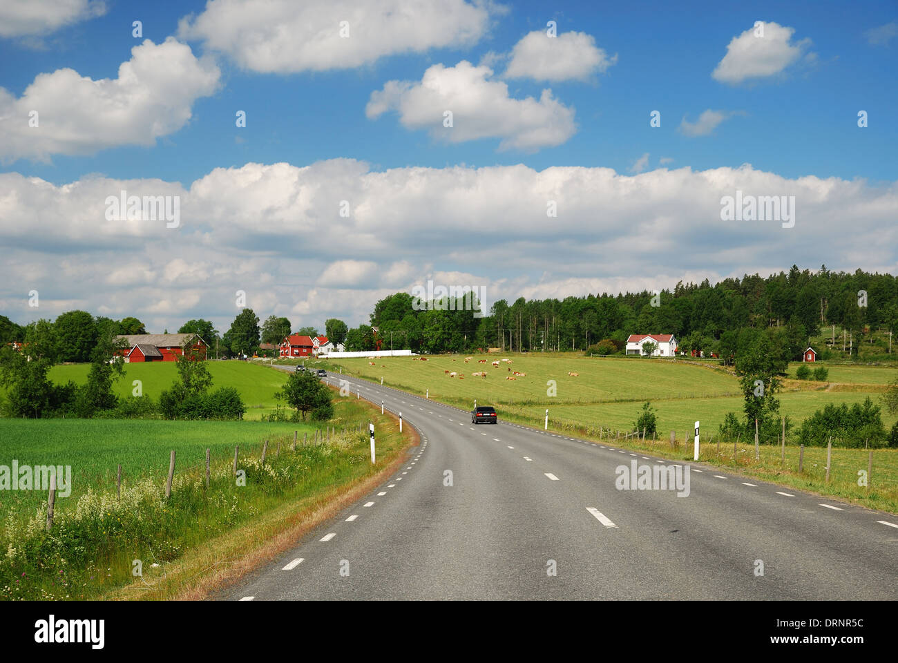 Country landscape with a road and farms Stock Photo - Alamy