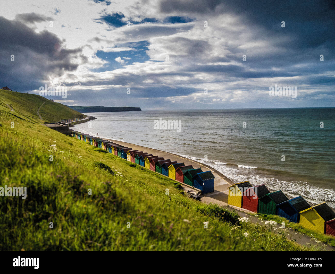 Beach Huts at the base of West Cliff, Whitby, North Yorkshire. Stock Photo