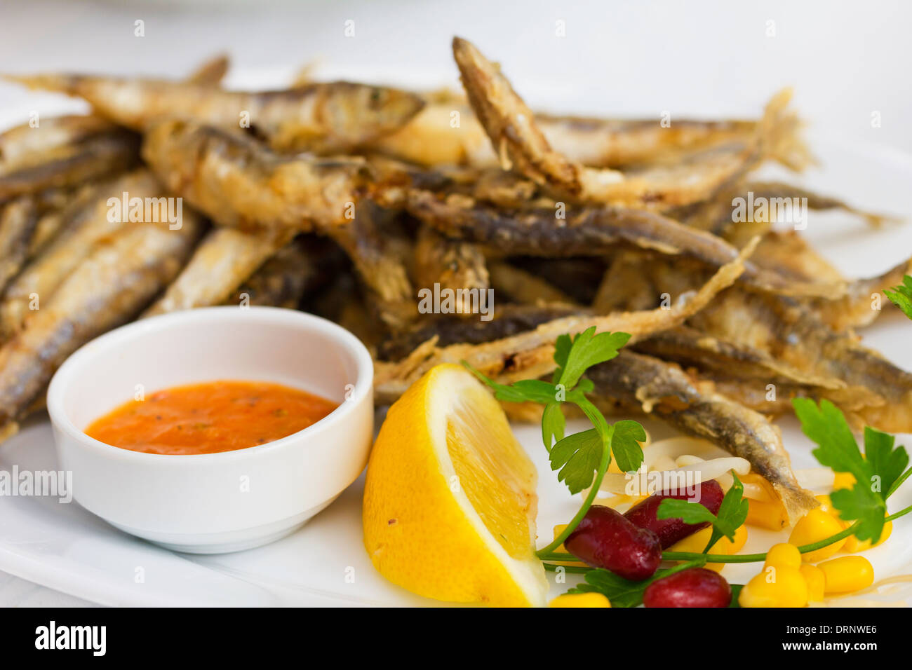 Fried fresh sprat fish with souce. Good seafood Stock Photo Alamy