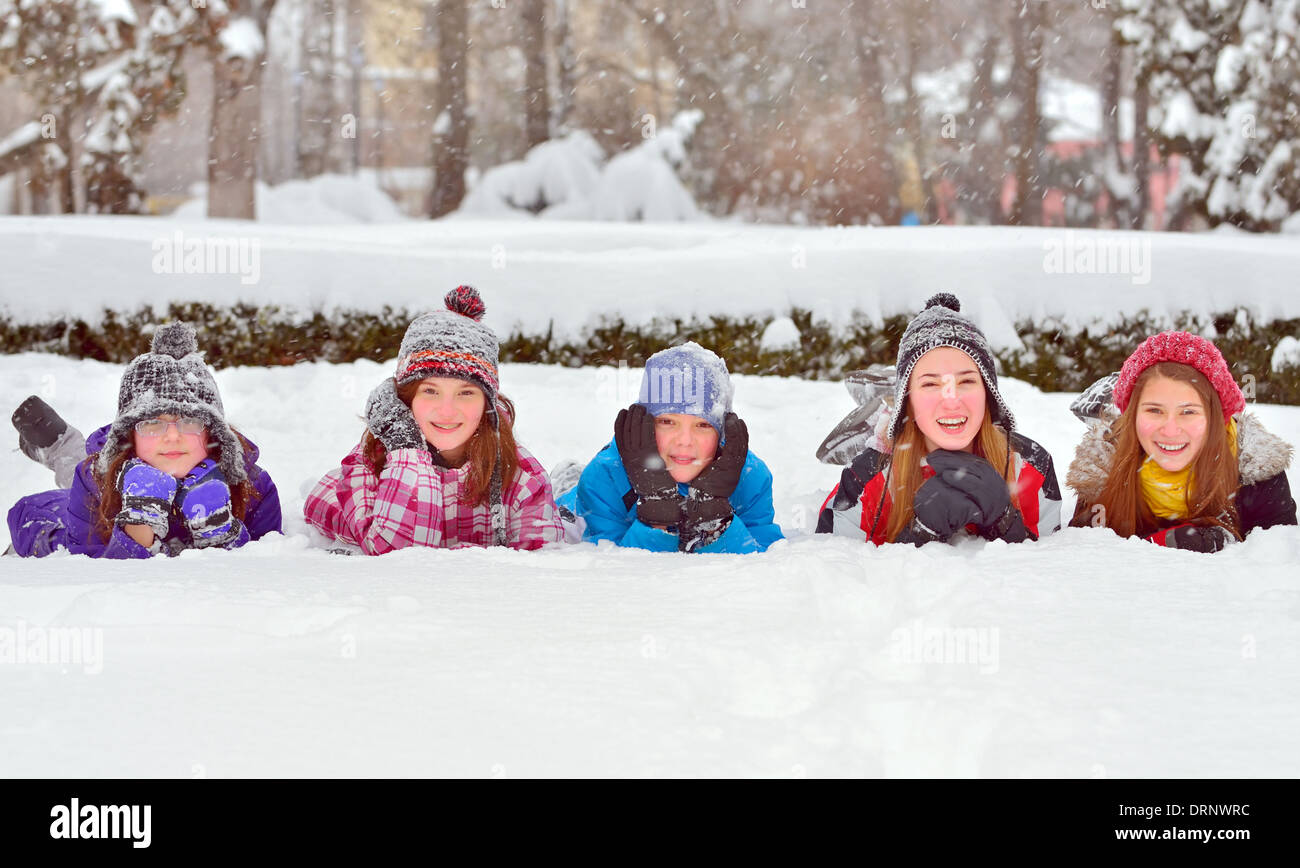 Group of children playing on snow in winter time Stock Photo - Alamy