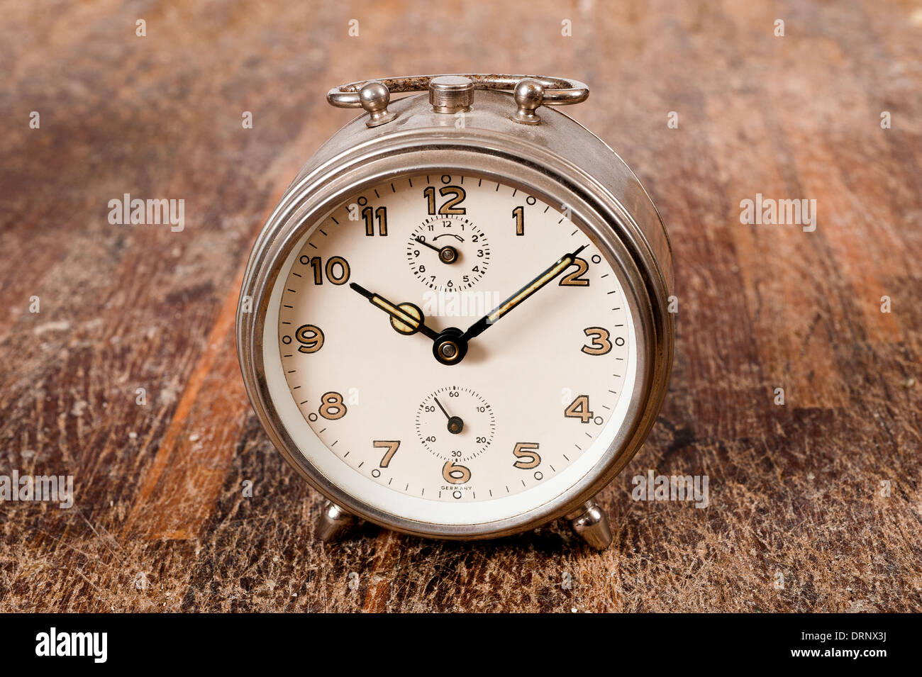 Vintage background with retro alarm clock on table Stock Photo