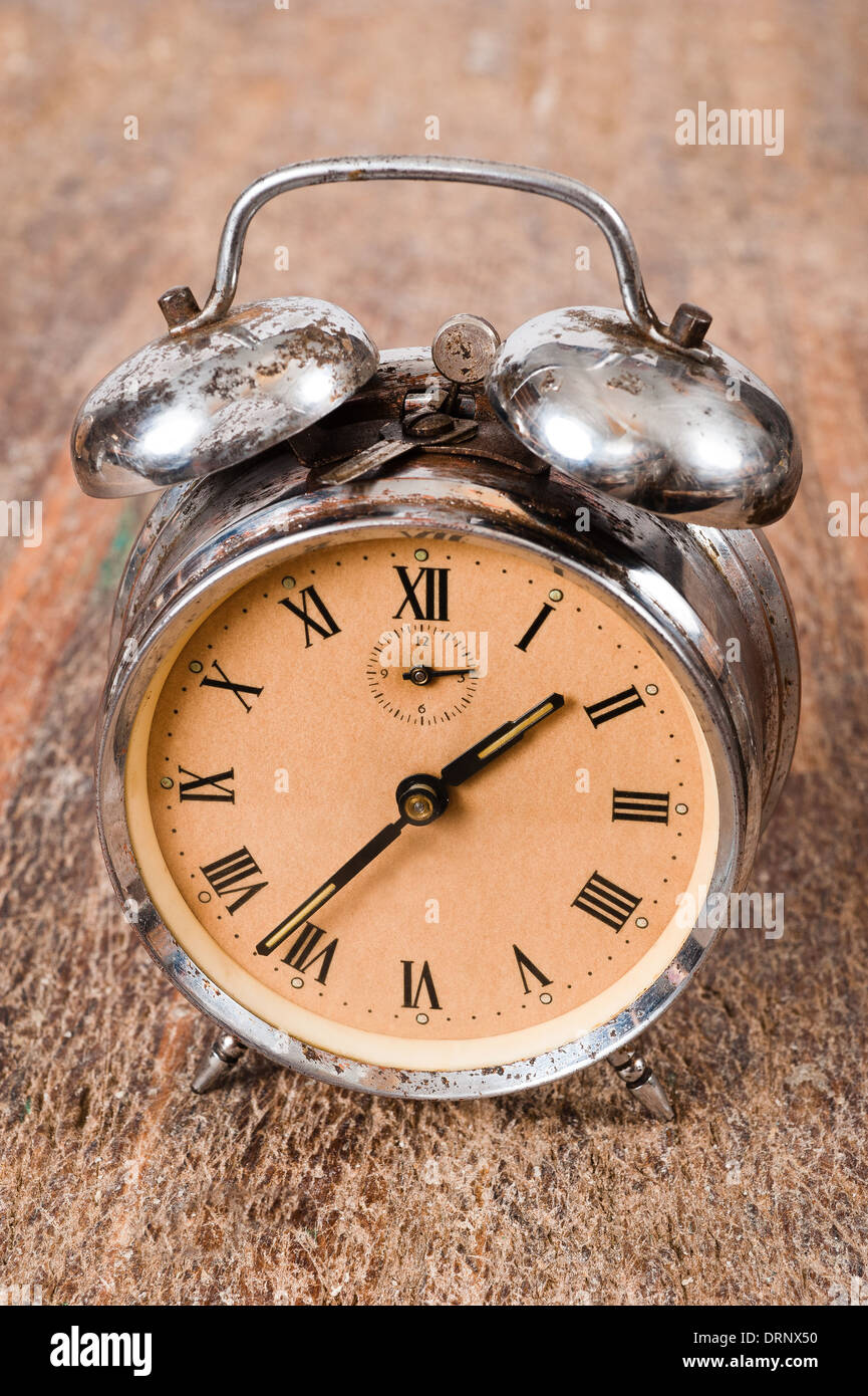 Vintage background with retro alarm clock on table Stock Photo