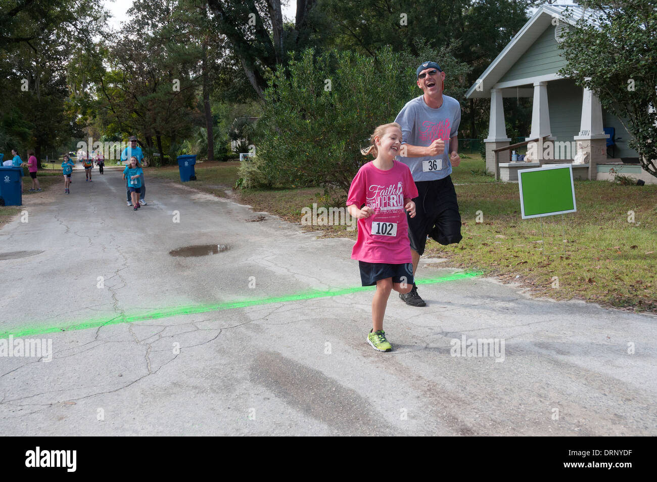 Crossing finish line at Crossroads Pregnancy Center annual 5K walk / run charity race in High Springs, Florida. Stock Photo