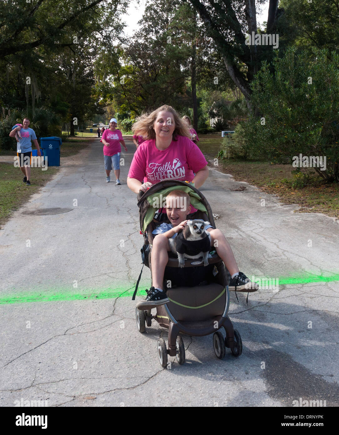 Crossing finish line at Crossroads Pregnancy Center annual 5K walk / run charity race in High Springs, Florida. Stock Photo