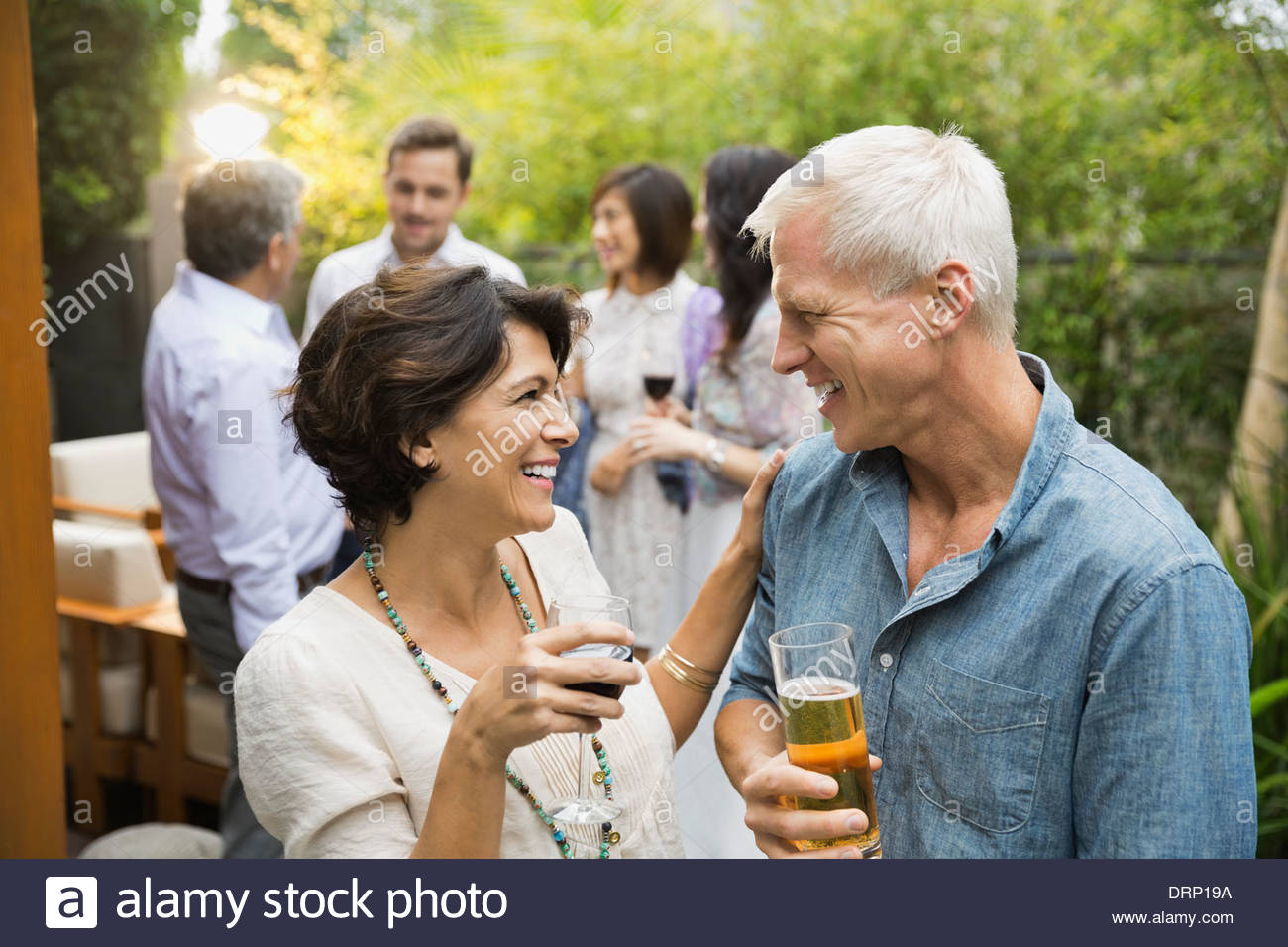 Couple with drinks at outdoor party Stock Photo