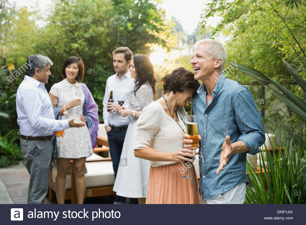 Couple with drinks at outdoor party Stock Photo
