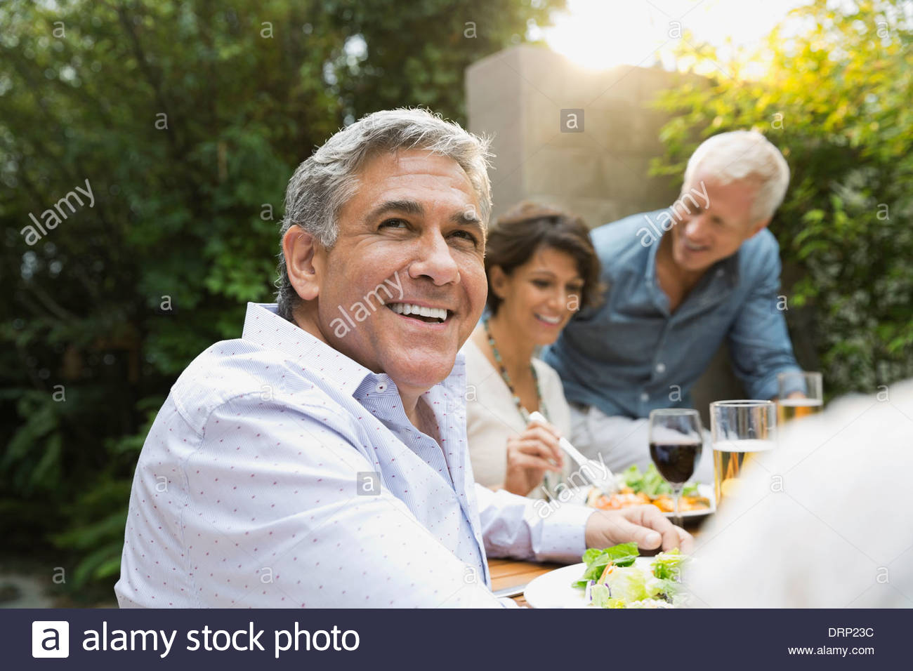 Man enjoying outdoor dinner party Stock Photo