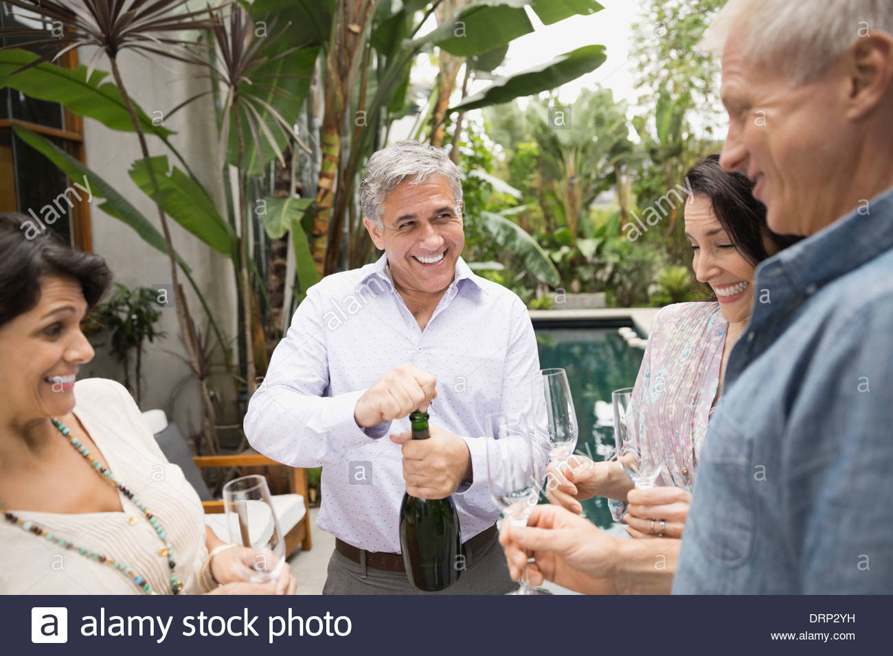 Man opening champagne bottle Stock Photo