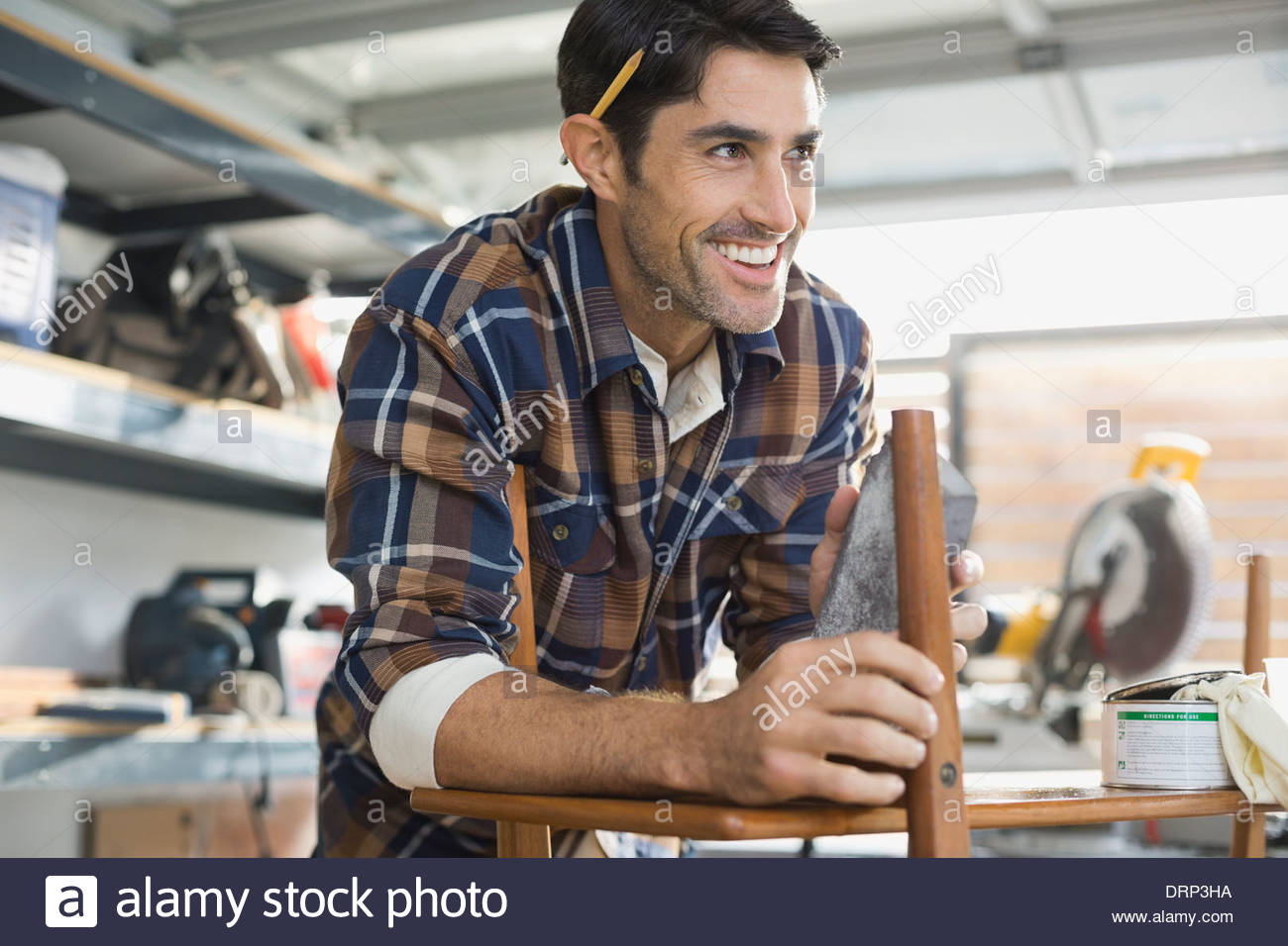 Carpenter smiling in workshop Stock Photo