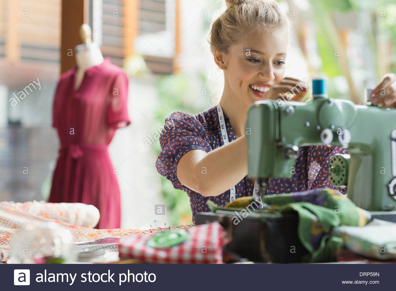 Fashion designer threading sewing machine Stock Photo