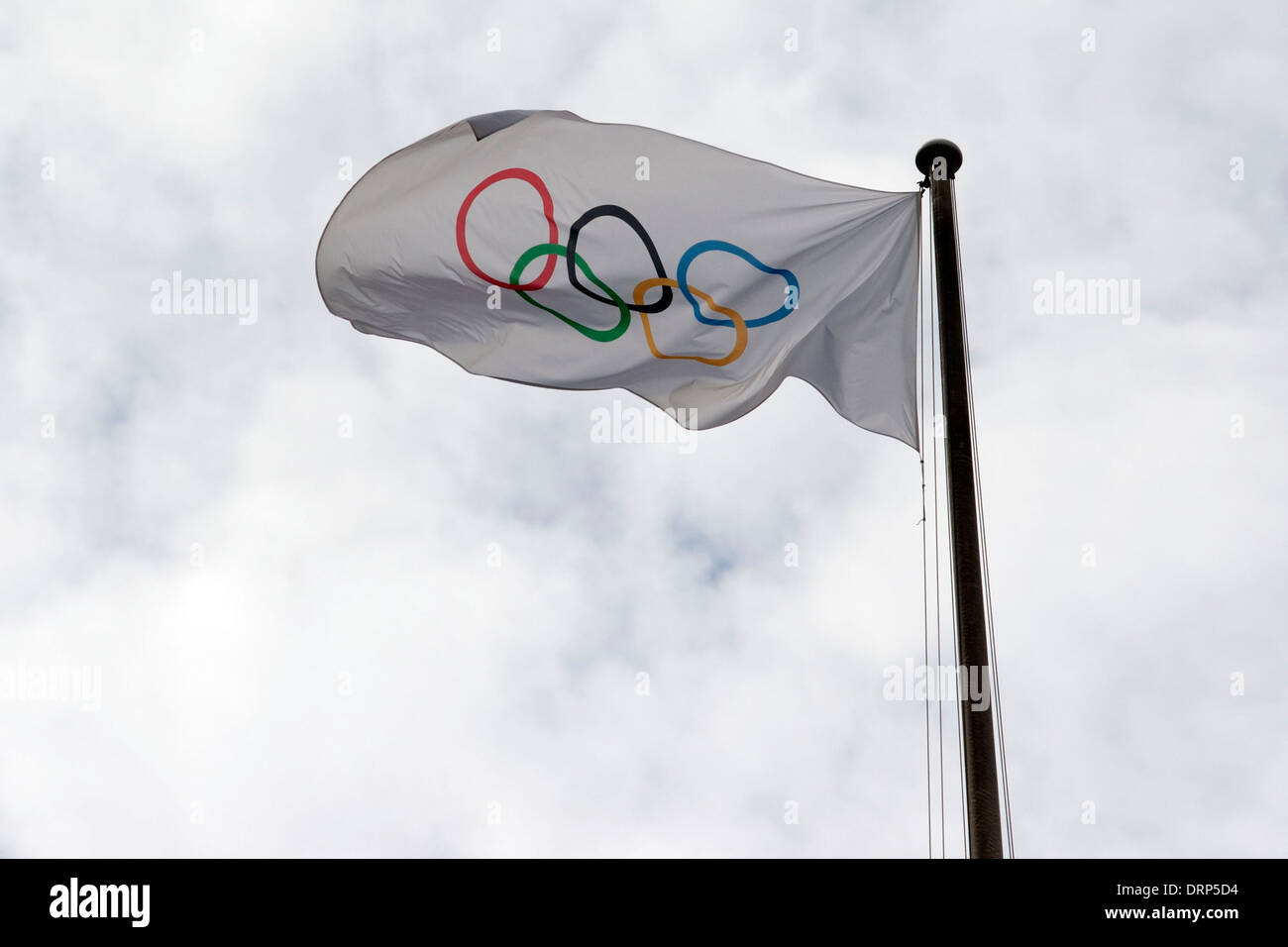 The Olympic flag flutters in the wind Stock Photo