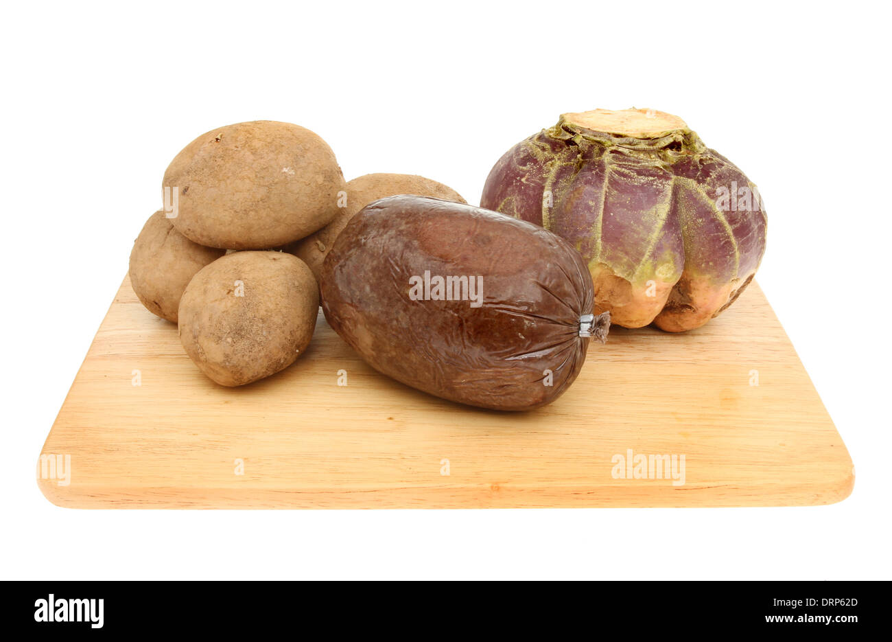 Haggis tatties and neeps on a wooden board isolated against white Stock Photo