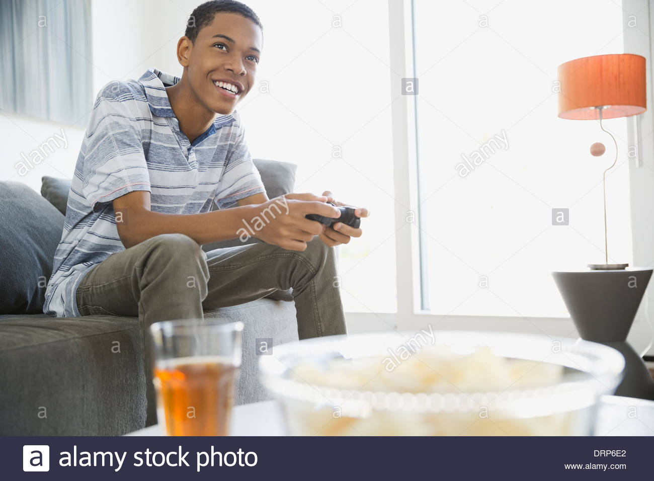 Teen playing video games at home Stock Photo