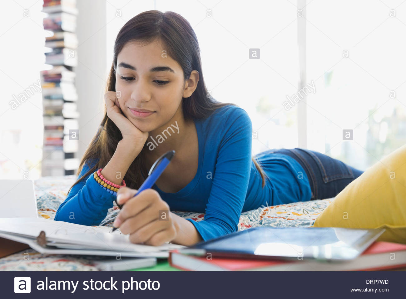 Girl studying in bedroom Stock Photo