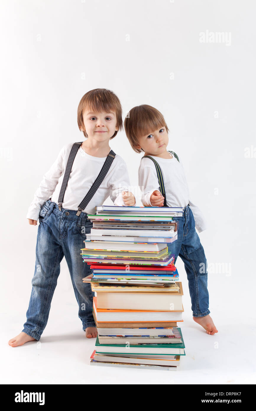 Two boys with a pile of books Stock Photo - Alamy