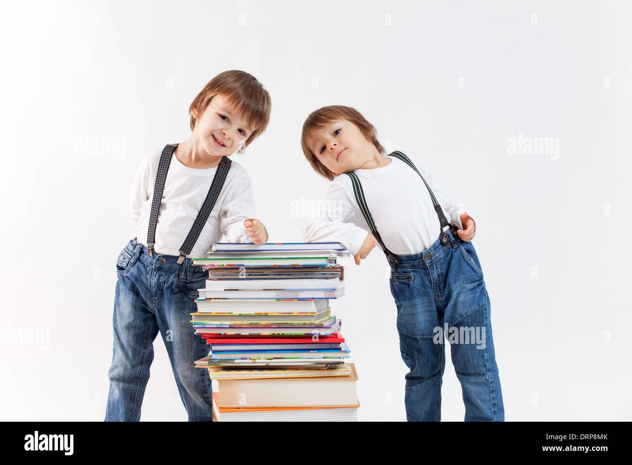 Two boys with a pile of books Stock Photo - Alamy