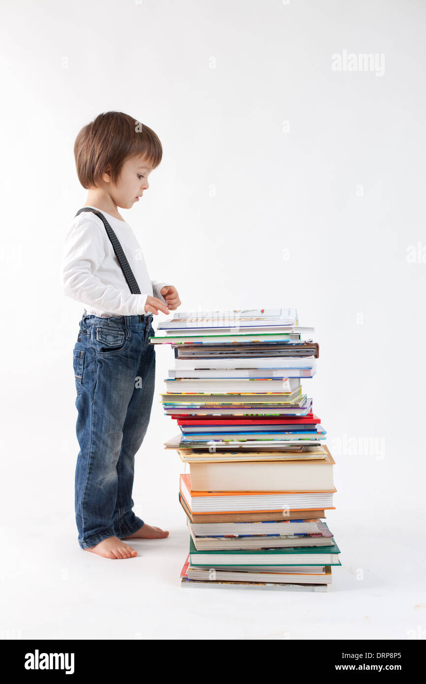 Boy with a pile of books Stock Photo - Alamy