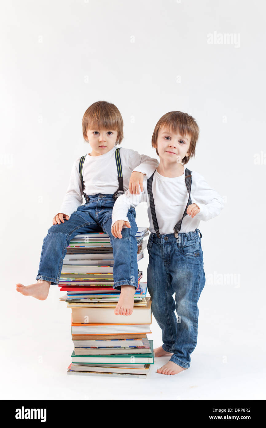 Two boys with a pile of books Stock Photo - Alamy