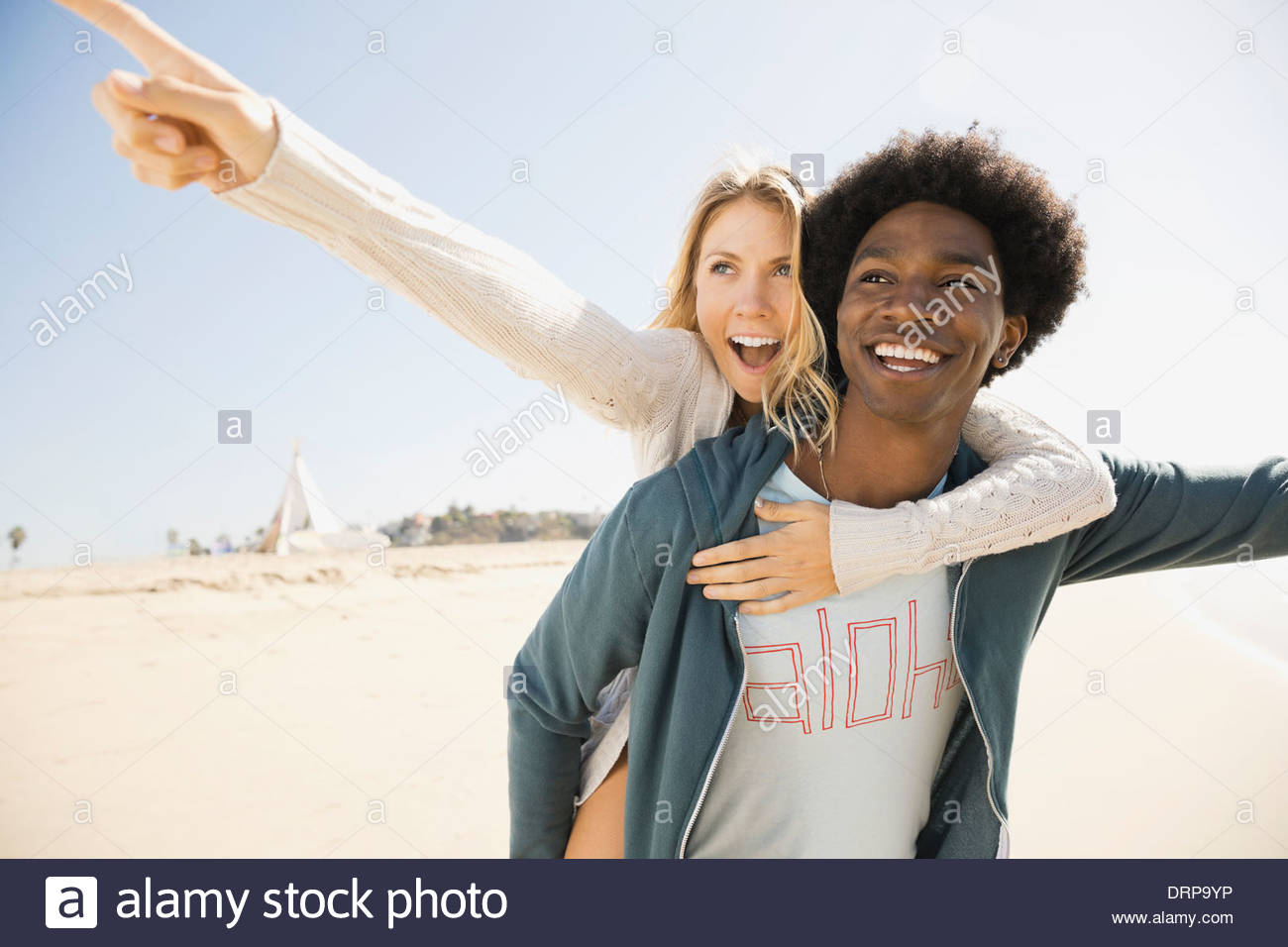 Excited couple on beach Stock Photo