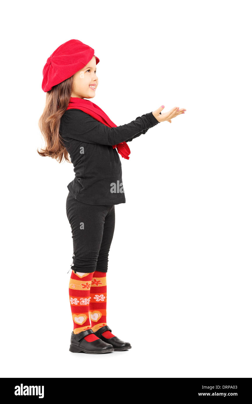 Full length portrait of a cute little girl trying to take something and looking up Stock Photo