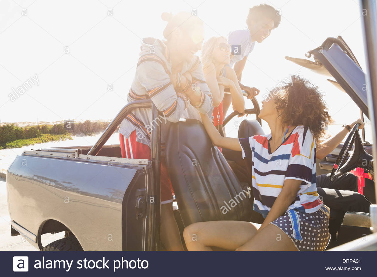 Group of friends taking a day trip to the beach Stock Photo
