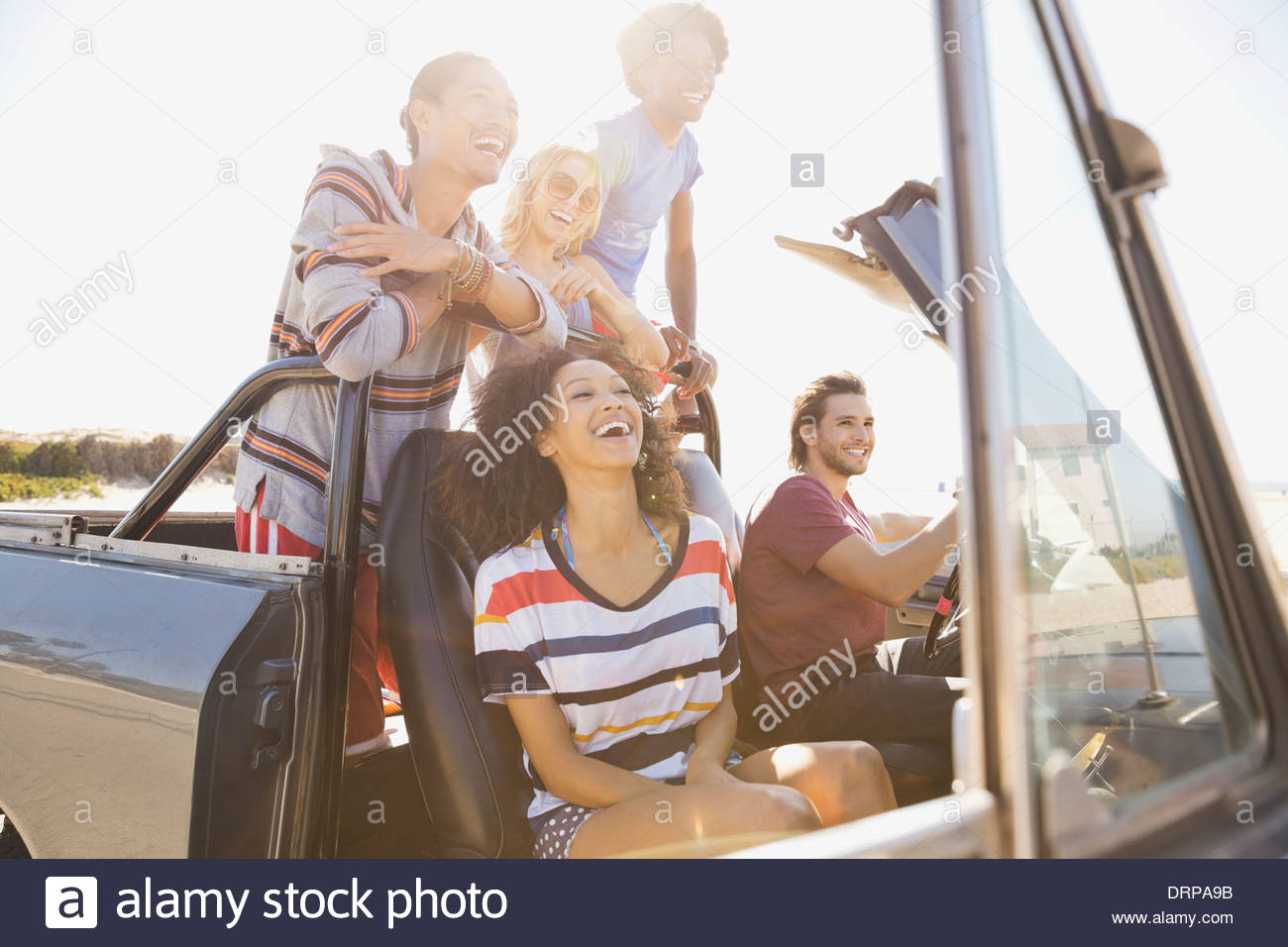 Group of friends taking a day trip to the beach Stock Photo