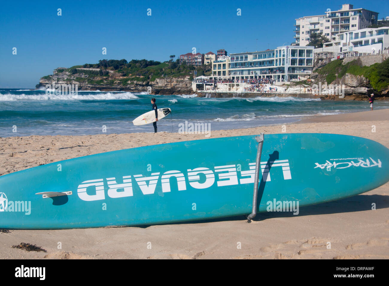 Bondi Beach lifeguard surfboard, young surfer holding board looking out to sea Sydney New South