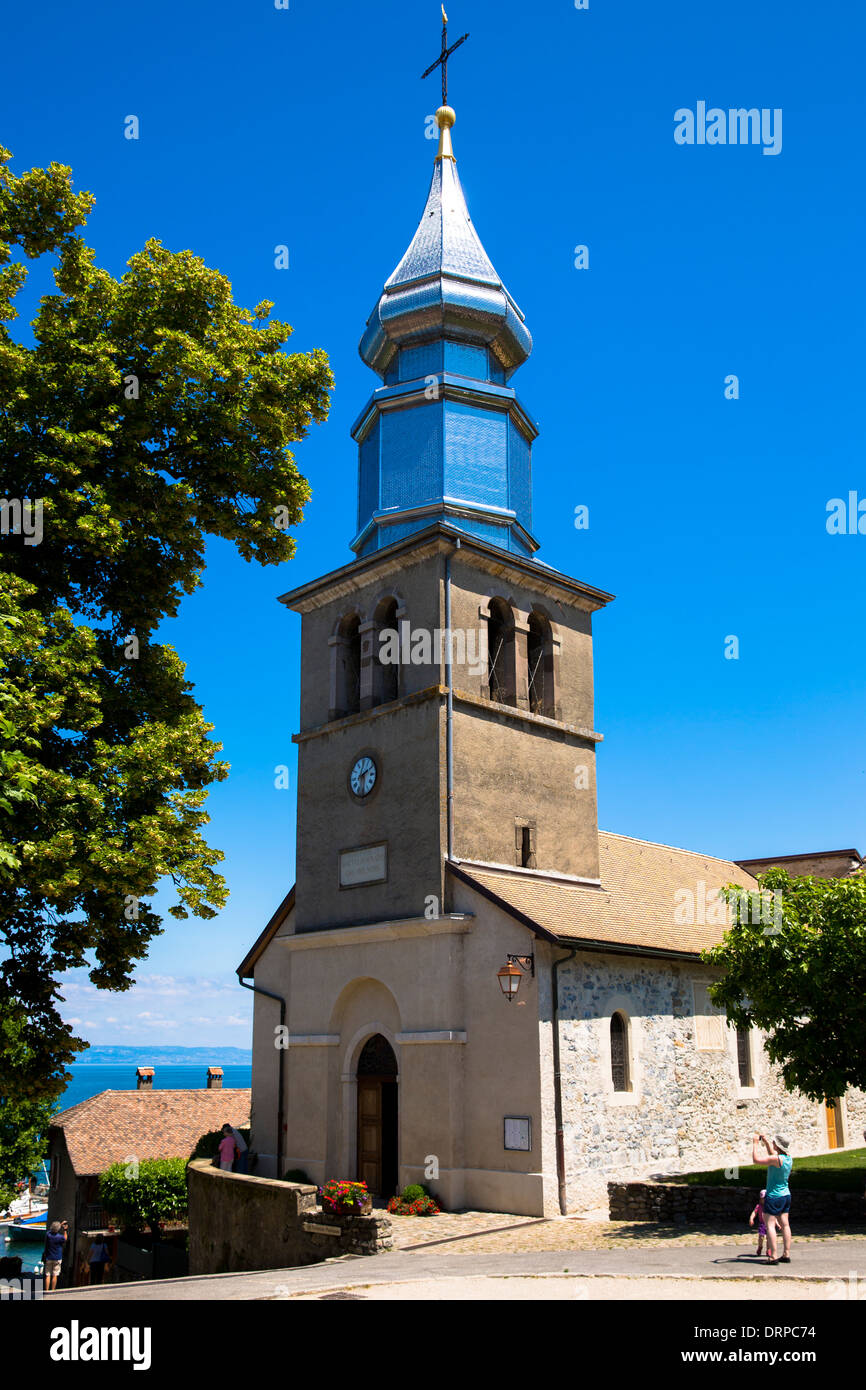 Tourist photographs Saint Pancrace d'Yvoire church in the old district of Yvoire by Lac Leman, Lake Geneva, France Stock Photo