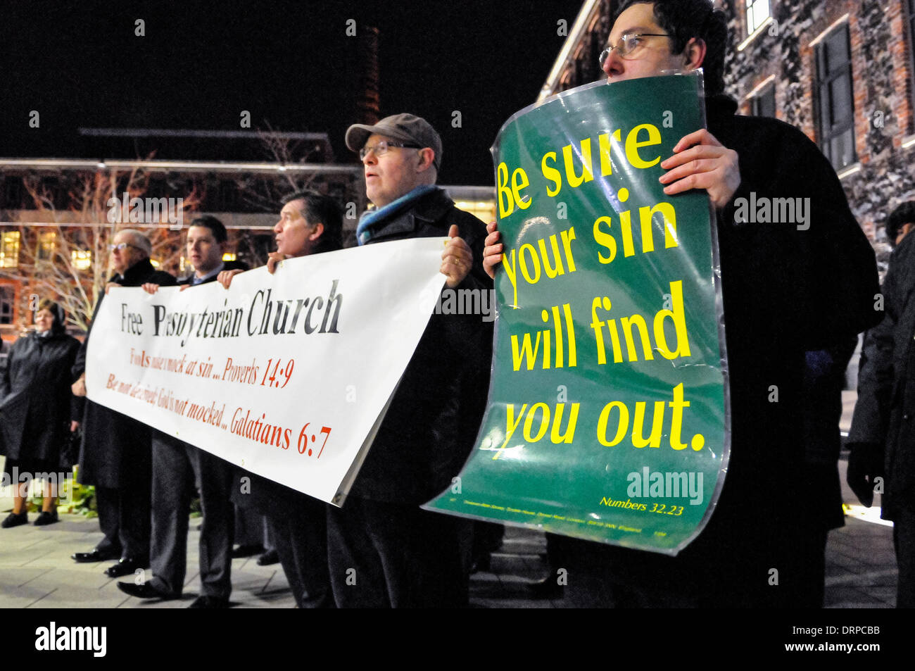 Newtownabbey, Northern Ireland. 30 Jan 2014 - Protesters from the Free Presbyterian Church hold posters saying "Be sure your sin will find you out", while they sing hymns outside a theatre, which is hosting a play they consider to be 'blasphemous' Credit: Stephen Barnes/Alamy Live News Stock Photo