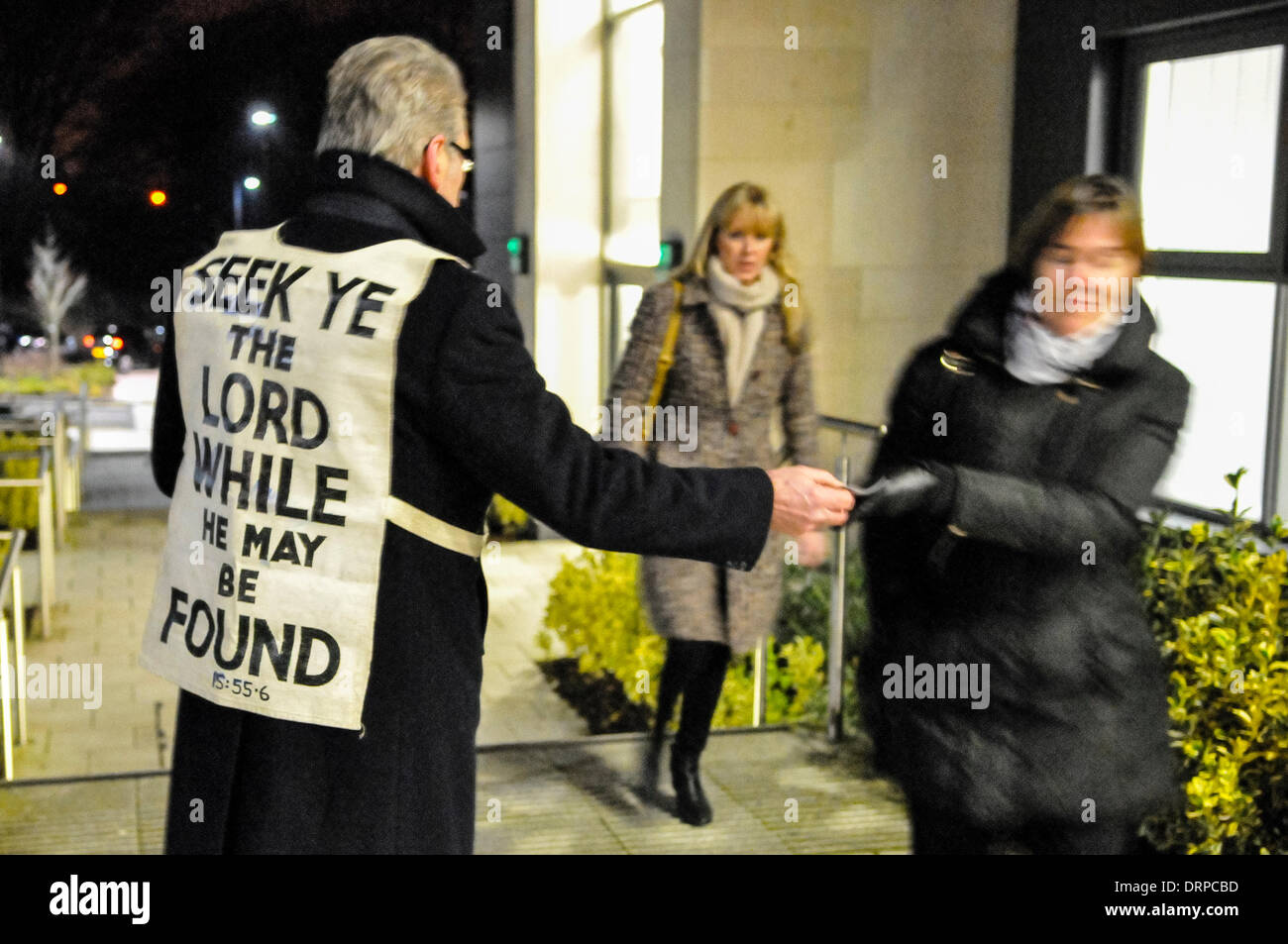 Newtownabbey, Northern Ireland. 30 Jan 2014  - A man wearing a bib with a bible verse, hands out gospel tracts to audience members going to see a play which they see as 'blasphemous'. Credit:  Stephen Barnes/Alamy Live News Stock Photo