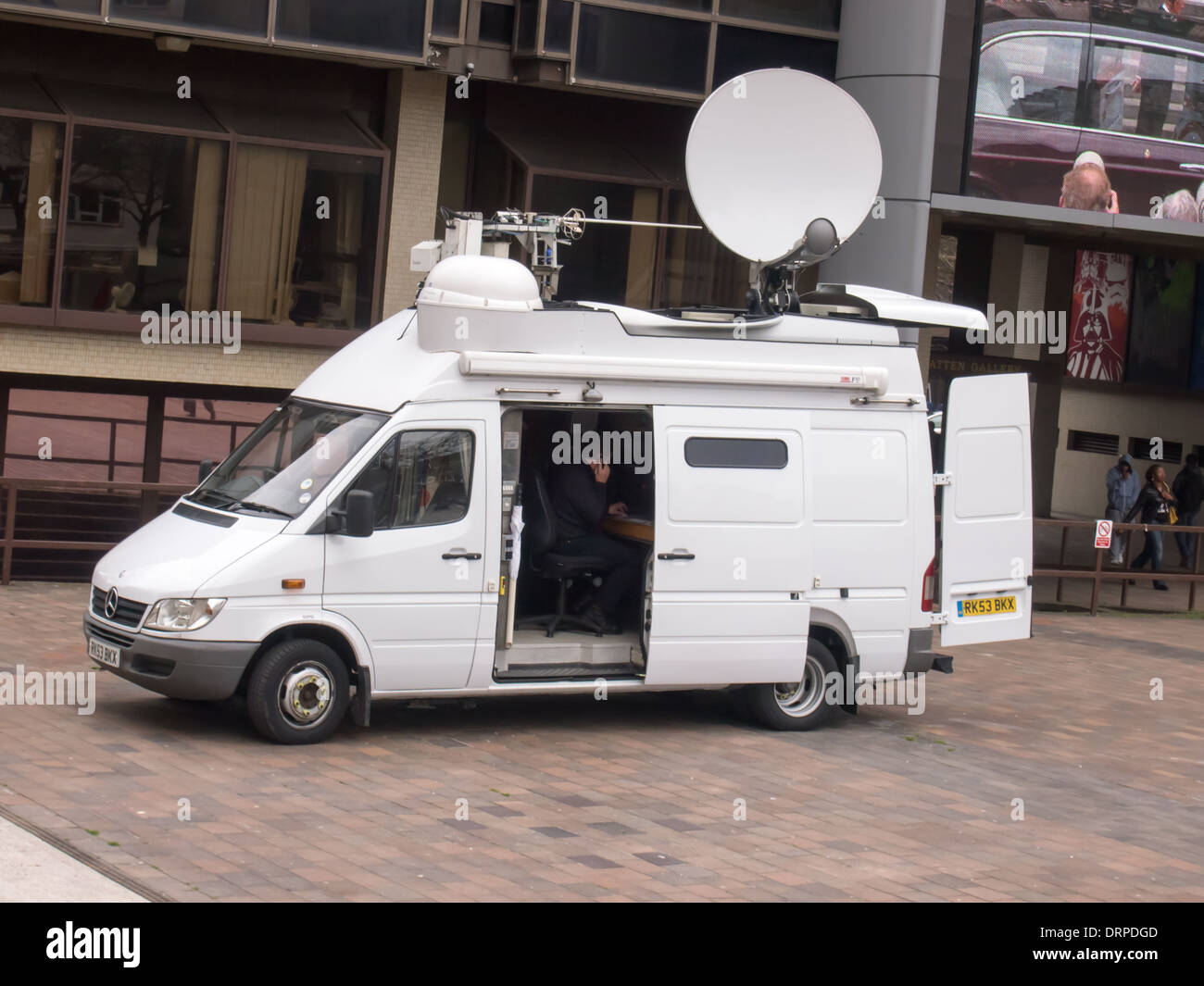 an outside broadcast communications van with receiving and transmitting dish Stock Photo